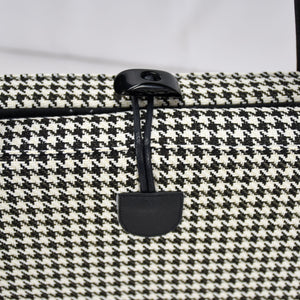 KONA CAVE® luxury Travel Dog Bed - Black and White Houndstooth with Black Quilted Alcantara faux suede lining, with front pocket for on-the-go dog essentials, vegan-leather shoulder straps, and toggle closure.  Portable, folded dog mat for restaurants, outside and hotels. City chic carried dog bed. Toggle closure for easy one handed closing. 